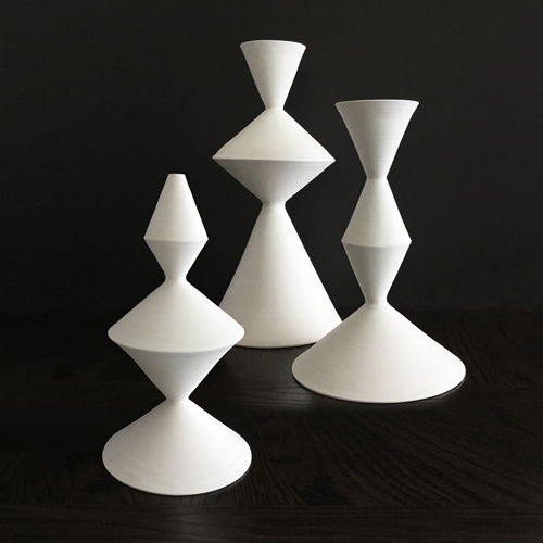 Ceramic sculptures, composed from modular handmade pieces. With a nod to mid-century modern, the geometric forms repeat playfully, complementing modern interiors and architecture. 11 to 15 inches tall, white stoneware, pottery decor.